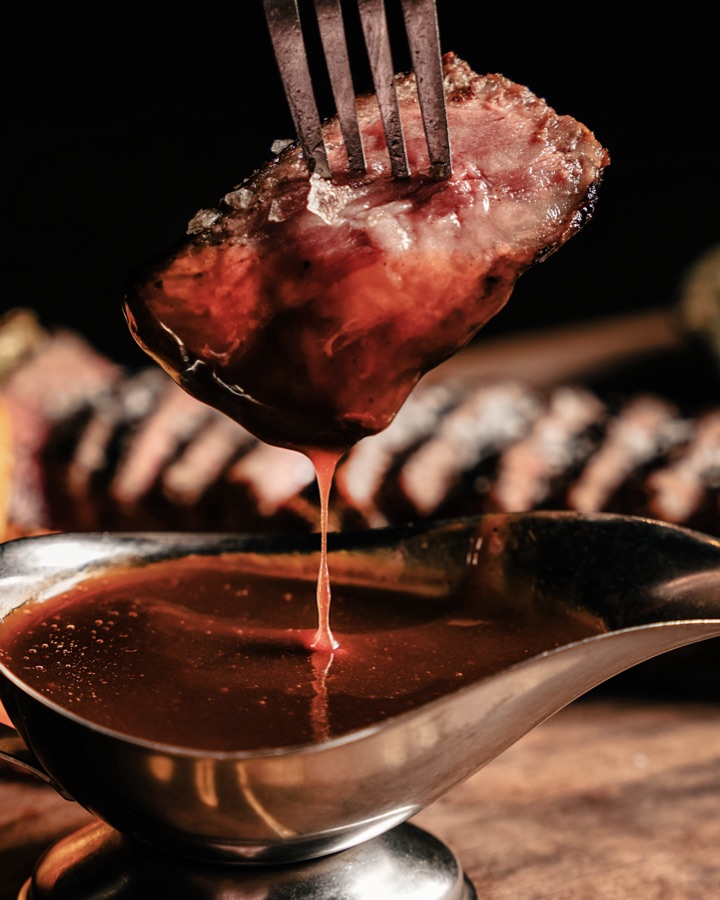 Steak finished with sauce at the table