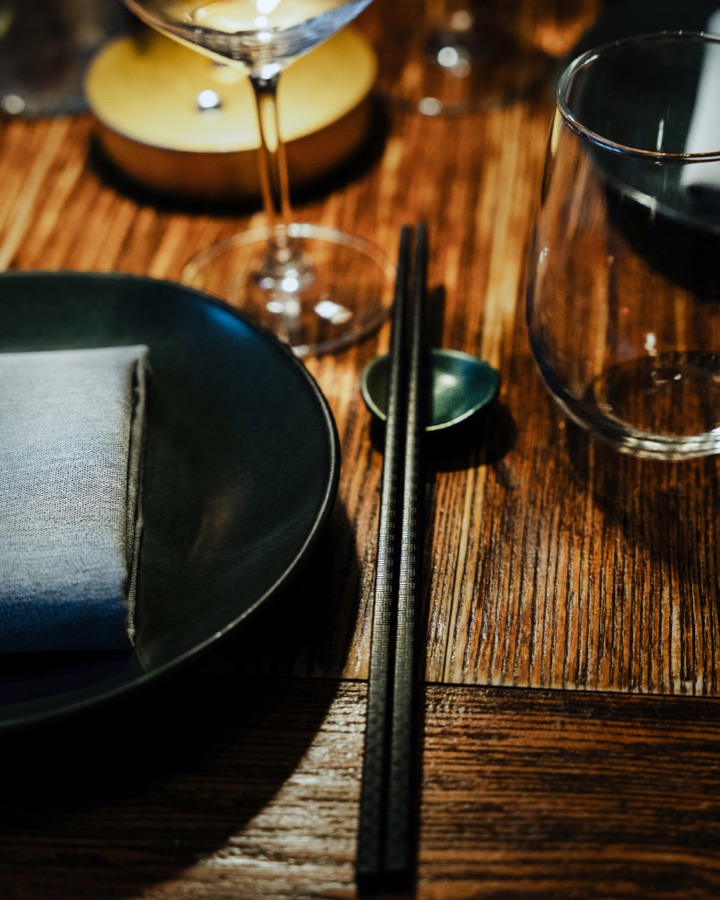 Table set with chopsticks and wine glasses